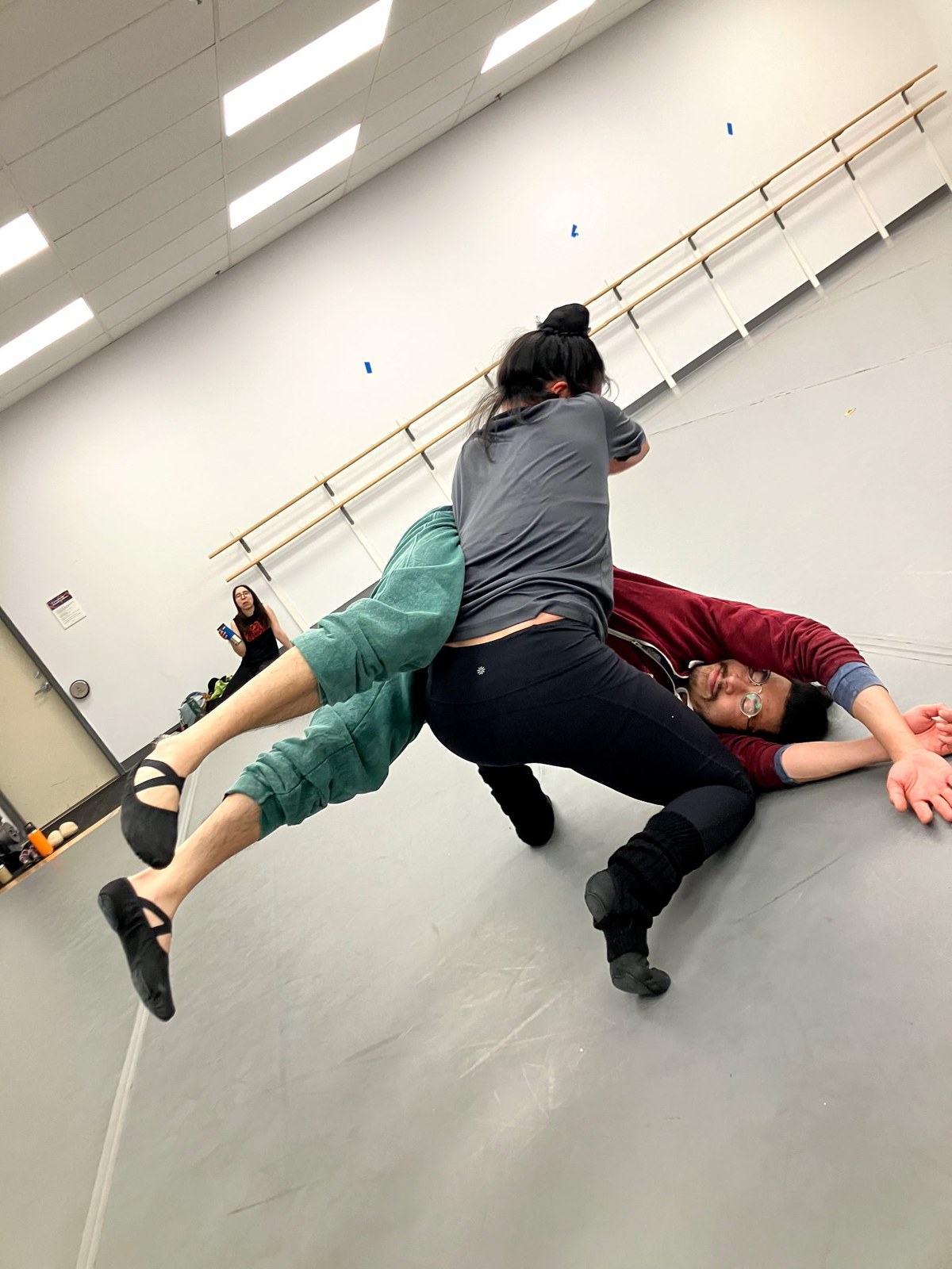 Alex practicing contact improvisation on the rehearsal floor.