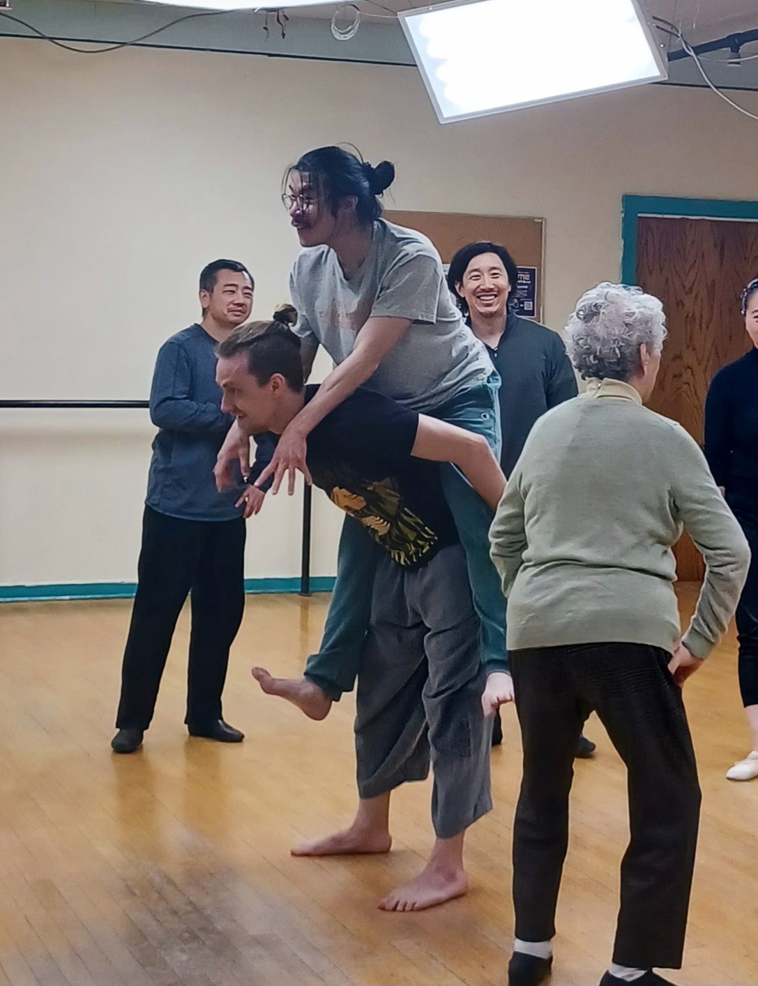 Alex and a partner rehearsing a supported movement in the dance studio.